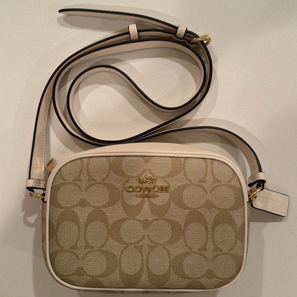 Coach Monogrammed cross body purse.